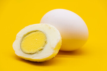 whole eggs and boil egg isolated on yellow background.