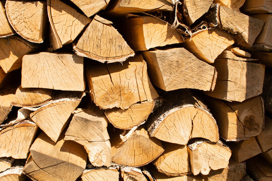 Finely chopped and stacked firewood. Stacks of Firewood. Preparation of firewood for the winter.