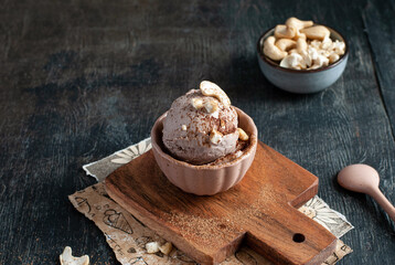 Homemade cashew and cocoa ice cream on a dark background