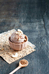 Homemade cashew and cocoa ice cream on a dark background
