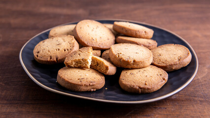 Freshly baked cookie biscuits with cumin spice on a plate. Jeera biscuits snacks, Indian cuisine...