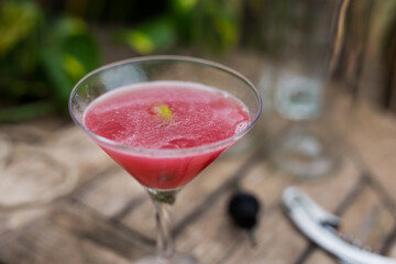  red cocktail with ice in a glass with a stem