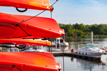 Red conoes  tie up at a dock in the port harbor