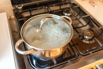 Boiling water inside a pot.Kitchen iron pot,top view,selective focus.
