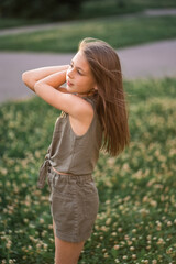 Obraz premium cute beautiful little girl on a background of green grass
