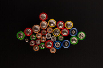 Composition with alkaline batteries on black background. Chemical waste. Top view