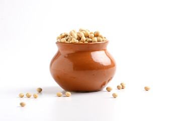 Dry soybean seed in bowl on white background.