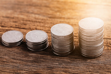 Stack of coins against wooden background - Money growth concept