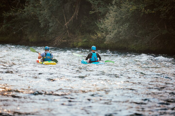 Two whitewater kayakers paddling on the waters of river. Adrenaline seekers and nature lovers.