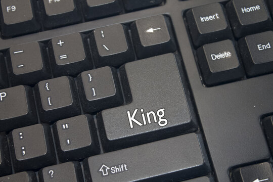 Black Computer Keyboard with King text. Close-up of an electronic Computer Device part, keypad.