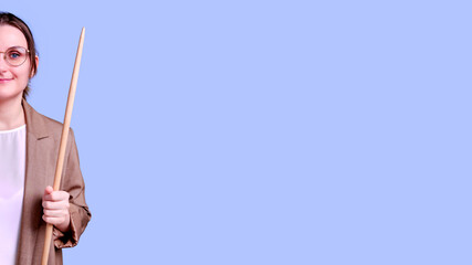 Smiling woman teacher on studio blue background, banner copy space