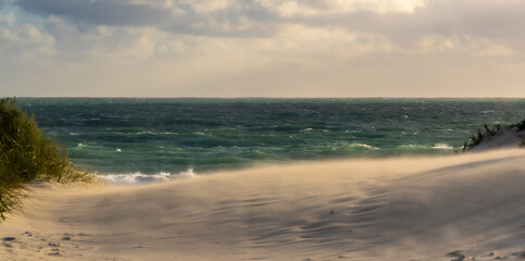 Sand twirling on the beach in storm