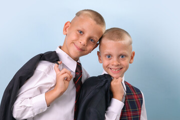 Portrait of two blond blue-eyed boys in suits