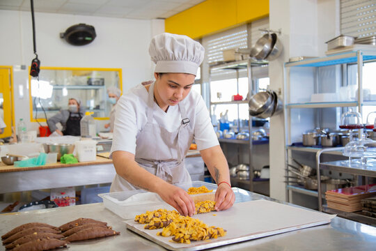 Woman making cookies in bakery