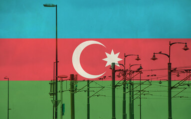 Azerbaijan flag with tram connecting on electric line with blue sky as background, electric railway train and power supply lines, cables connections and metal pole overhead catenary wire