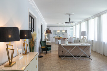 luxury interior of a modern apartment in bright colors with stylish furniture. kitchen, bedroom and living room area without walls.