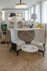 luxury interior of a modern apartment in bright colors with stylish furniture. kitchen, bedroom and living room area without walls.