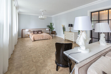 luxury interior of a modern apartment in bright colors with stylish furniture. kitchen, bedroom and living room area without walls.