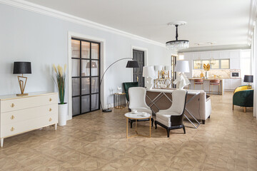 luxury interior of a modern apartment in bright colors with stylish furniture. kitchen, bedroom and living room area without walls.