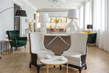 luxury interior of a modern apartment in bright colors with stylish furniture. kitchen, bedroom and living room area without walls.