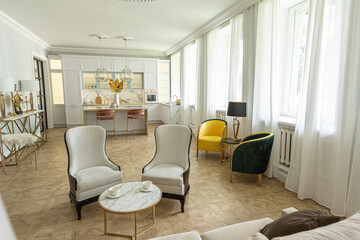 luxury interior of a modern apartment in bright colors with stylish furniture. kitchen, bedroom and living room area without walls.