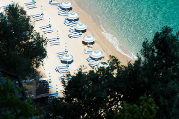 Wall murals Positano beach, Amalfi Coast, Italy View from above, stunning aerial view of some beach umbrellas on a beautiful beach bathed by a crystal clear water. Amalfi Coast, Italy.