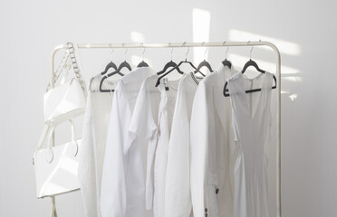 female white capsule summer wardrobe in  white room