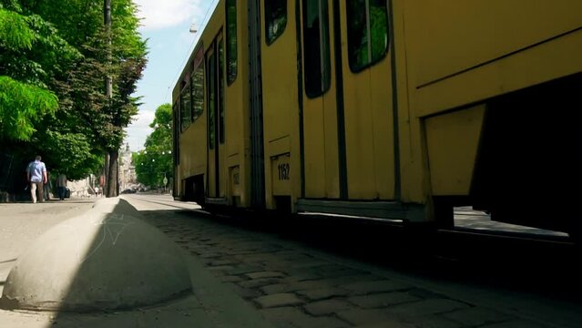 Lviv. UKRAINE. An old yellow tram rides down the street. Slow motion. Close-up vintage tram, retro transport. City eco-friendly public transport.
