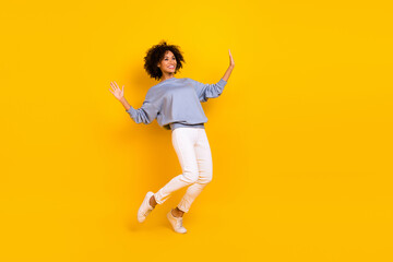 Full size photo of overjoyed carefree young lady enjoy dancing clubbing isolated on yellow color background