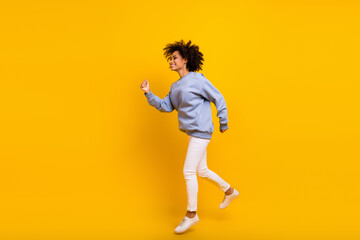 Fototapeta na wymiar Full body profile photo of excited sporty active person jump rush empty space isolated on yellow color background