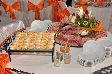 froid buffet table with canapes and savory snacks with meats fruits cheeses with decorations of...