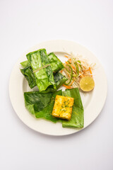 patrani paneer, a paneer marinated in sauce and barbecued and then covered in leaf