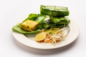 patrani paneer, a paneer marinated in sauce and barbecued and then covered in leaf
