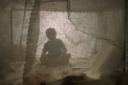 Silhouette Of Little Boy Playing Inside Tent House