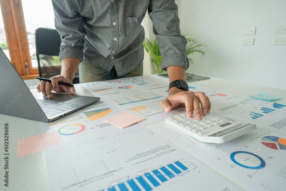 Poster an accountant working at a desk using a calculator for calculating finance reports in the office