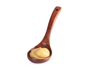 Wooden spoon with Dijon mustard on a white background.