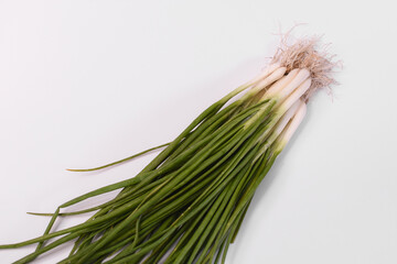 Fresh organic leeks on a white background.