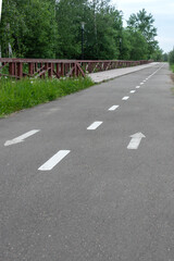 Asphalt bike path parallel to the eco-trail in the public park.