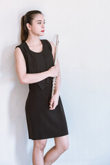 Girl with a flute isolated background. © May Chanikran