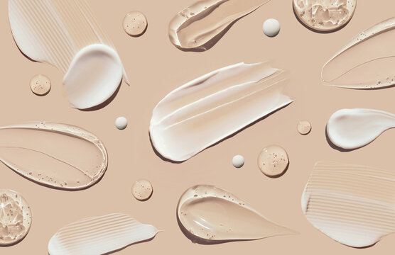 pattern cosmetic smears of creamy texture on a pastel beige background