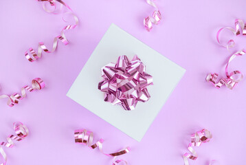 gift box with festive confetti on pastel light pink background