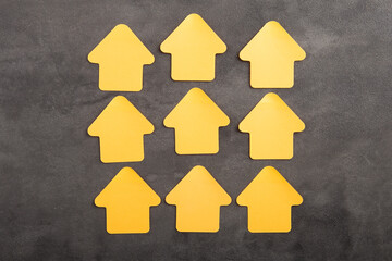 Blank yellow house shaped sticky note - real estate concept