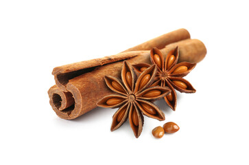 Aromatic cinnamon stick and anise stars with seeds on white background