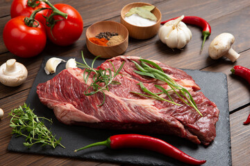 Raw beef steak on wooden table top. Healthy food concept. beef cut and spices for cooking bbq sauce