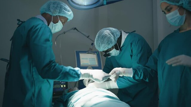 African American professional team of doctors and surgeons processing surgical operation in operating room modern hospital emergency department.