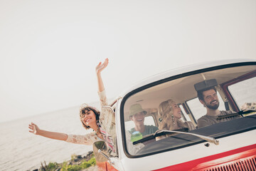 Photo of millennial funky company go by car on holiday trip wear trend cloth by the sea outside