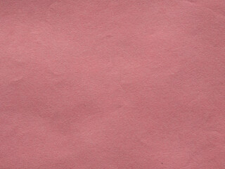 Natural light red paper texture for the background. The structure of the surface of light pink kraft cardboard