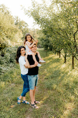 Beautiful young family on vacation in the park outdoors