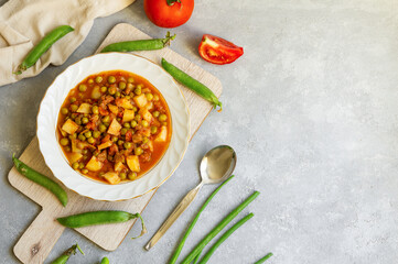 Fresh organic meaty green pea food with tomato and potato, homemade vegeterian meal