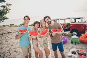 Photo of nice fellows hold slice watermelon enjoy sunset party wear boho outfit nature seaside beach outside